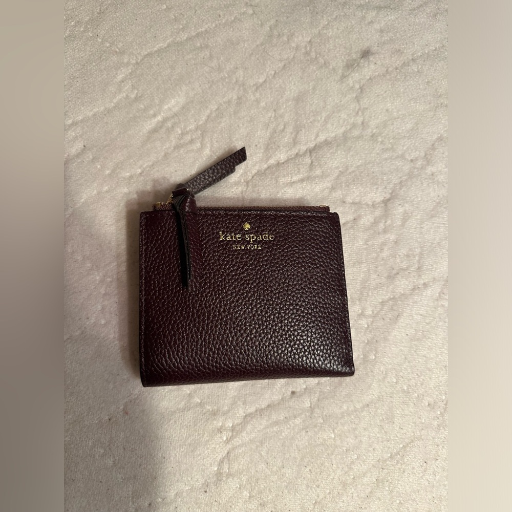 Brand New Kate Spade Wallet with tags in the color Burgundy/Plum